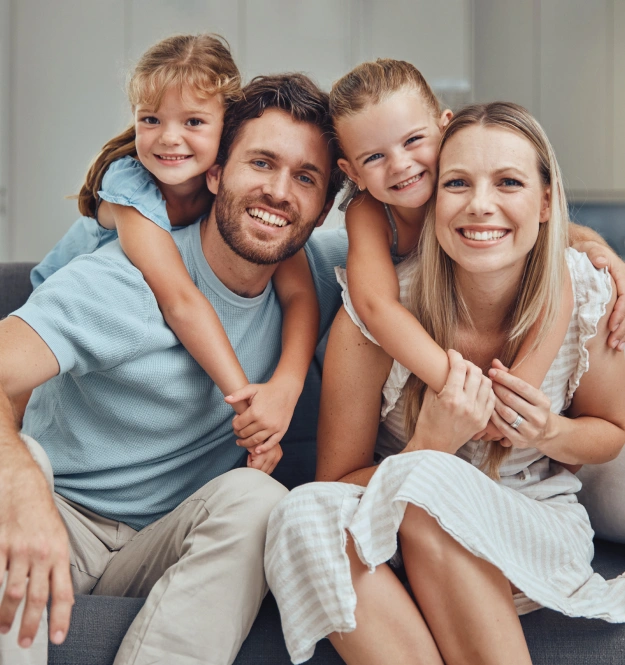 Family smiling together while benefiting from convenient evening dental appointments